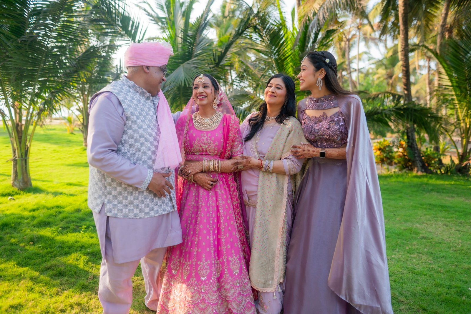 The bride with her family in a palm garden at her Goa wedding