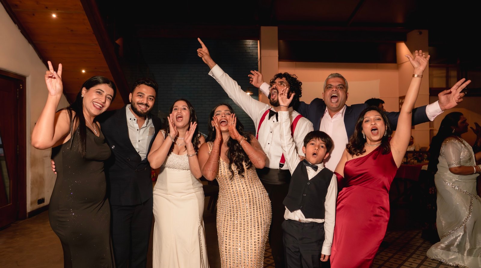 Guests cheering on the dance floor at a wedding reception in Mumbai